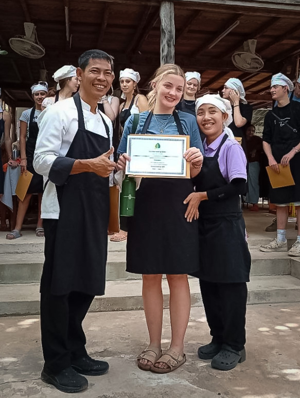 Chef Sophos with student holding certificate of cooking class completion in siem reap